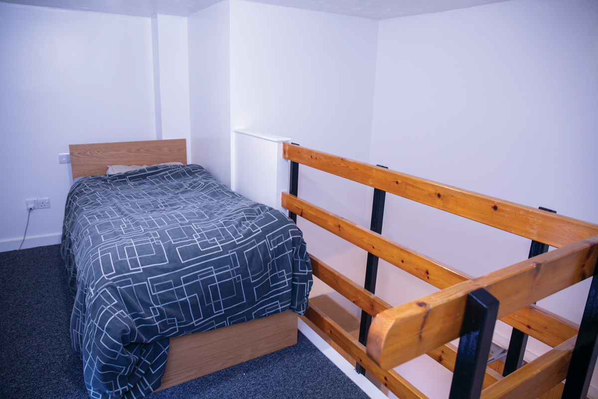 A bed on a mezzanine floor at Devonport House